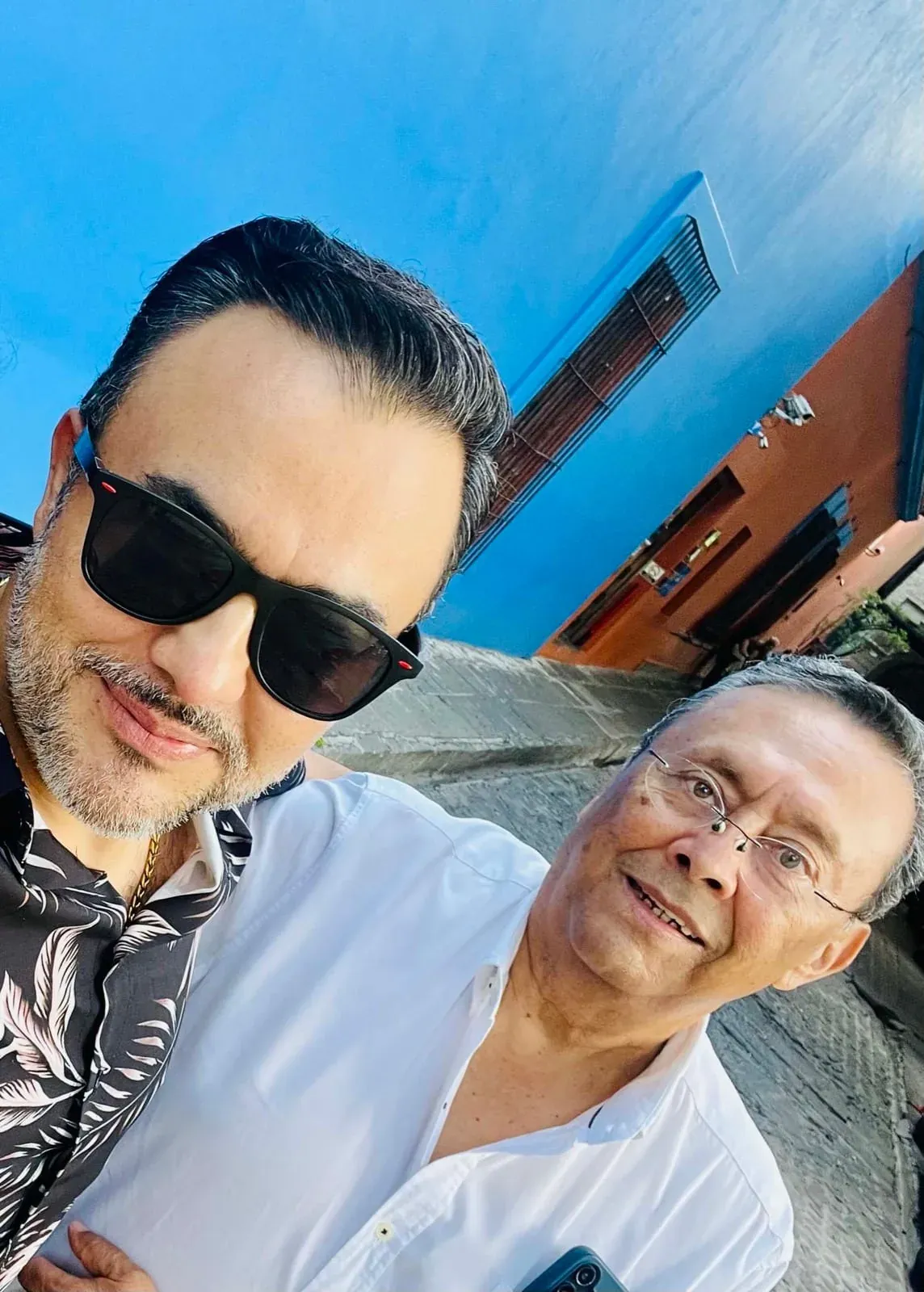 Arturo Ordorika and his father, Captain Zepeda, on a street in the sunlight