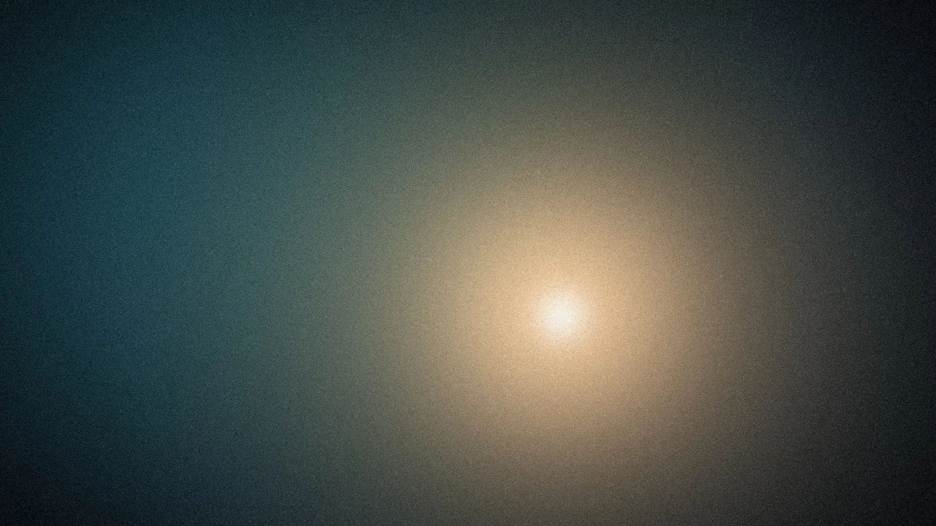 A warm gold glow in an abyssal dawn, with teal moonlight bleeding in from one side